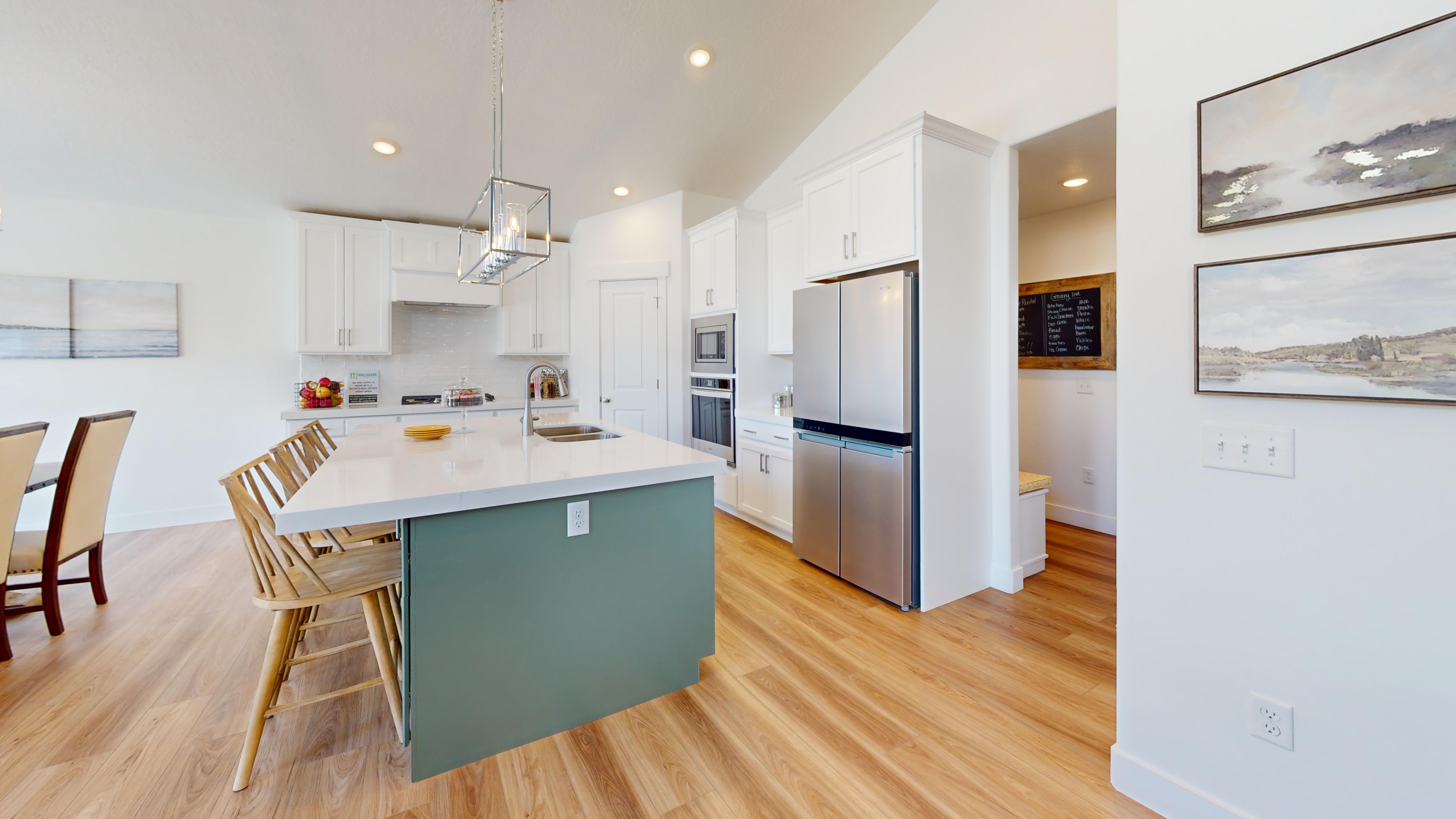 Denali model kitchen with white cabinetry and green island